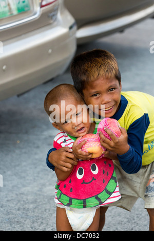 Petits garçons mendicité dans la ville de Makati à Manille, Philippines Banque D'Images