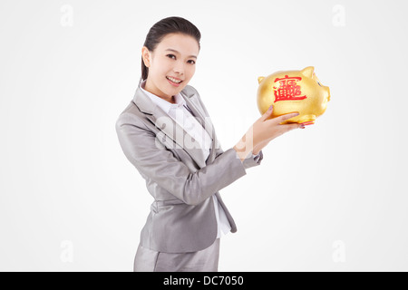 Femme d'affaires oriental and piggy bank Banque D'Images