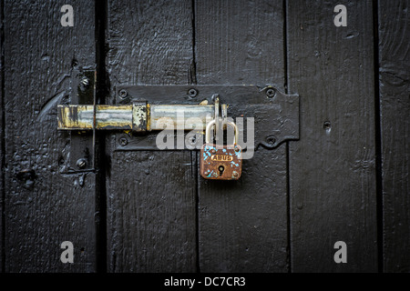 Fermoir et cadenas sur la porte en bois noir Banque D'Images