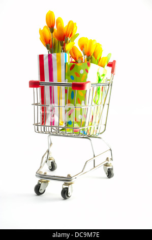 Un panier avec des sacs-cadeaux remplis de fleurs Banque D'Images
