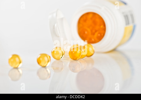 Capsules d'huile de poisson contenant ouvert, renversé Banque D'Images