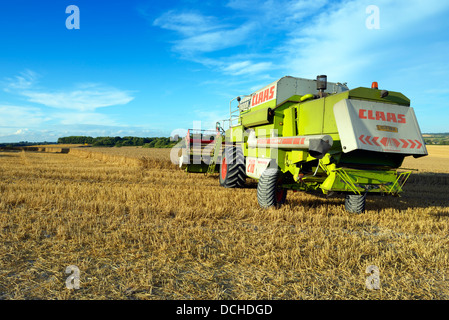 Une moissonneuse-batteuse au travail sur les South Downs dans l'East Sussex, UK Banque D'Images