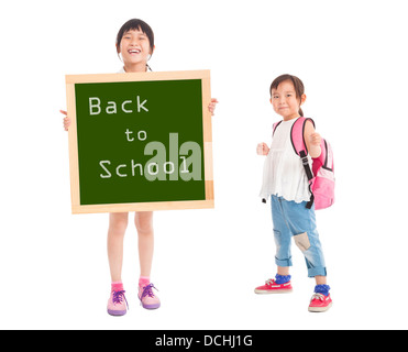 Heureux les petites filles montrant de nouveau à l'école avec tableau noir Banque D'Images