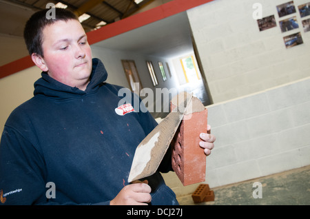 Blanc jeune apprenti bricklayer et platerer dans l'enseignement universitaire a métier qualifié Banque D'Images