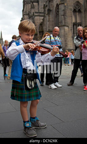 Édimbourg, Écosse, 20 août 2013, Colin McGlynn de Virginie aux États-Unis à l'âge de 7 ans pourrait être le plus jeune musicien ambulant sur le Royal Mile, au cours de l'Edinburgh Fringe Festival 2013. Il a diverti les passants en jouant des airs écossais sur son violon Banque D'Images