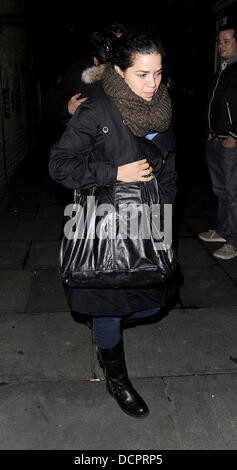 Ugly Betty Star et maintenant avec comme Roxie Hart dans Chicago, America Ferrera quitte un restaurant avec son petit ami. Elle semblait avoir des problèmes avec la météo anglaise comme elle a couvert sa bouche avec un foulard qu'elle toussait. Londres, Angleterre - 08.11.11 Banque D'Images