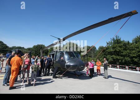 Les gens regardent le SAR Bell UH-1D'hélicoptère de l'Armée de l'air, surnommé 'Anneliese', en face de l'Hôpital Militaire de Hambourg, Allemagne, 24 août 2013. Les pilotes de sauvetage des Forces armées allemandes de célébrer leur 40e anniversaire. Photo : MALTE CHRÉTIENS Banque D'Images