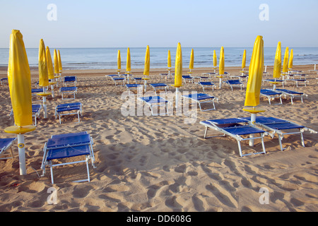 Plage vide avec des chaises et des parasols dans le matin Banque D'Images