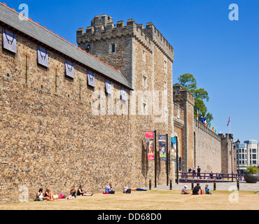 Les gens assis près de la porte d'entrée sud du château de Cardiff Cardiff City Centre South Glamorgan South Wales GB UK EU Europe Banque D'Images