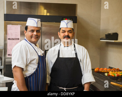 Chefs smiling in kitchen Banque D'Images
