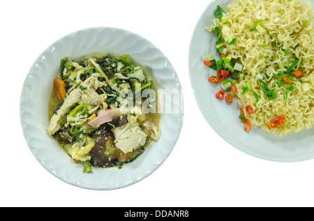 Vue supérieure de la soupe asiatique avec du porc , mélanger dans un bol de légumes cuits et des nouilles instantanées sur le plat blanc Banque D'Images