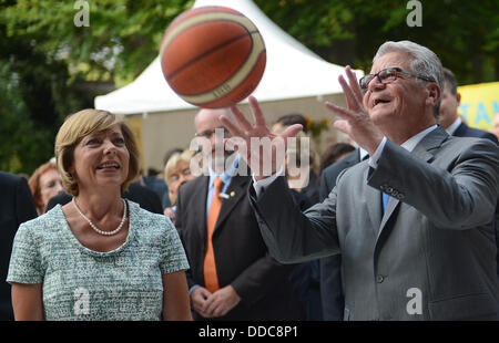 Berlin, Allemagne. Août 30, 2013. Le Président allemand Joachim Gauck (R) jette une basket-ball au Parti des citoyens dans les jardins du château de Bellevue à Berlin, Allemagne, 30 août 2013. Son partenaire Daniela Schadt (L) se trouve à côté de lui. Photo : BRITTA PEDERSEN/dpa/Alamy Live News Banque D'Images