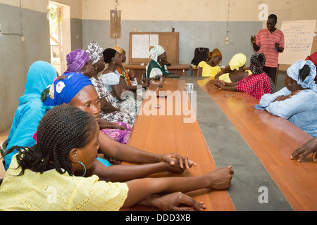 La microfinance. Les femmes qui reçoivent l'instruction dans la façon d'estimer les coûts de la plantation et la fertilisation d'une récolte. Kaymor, Sénégal Banque D'Images