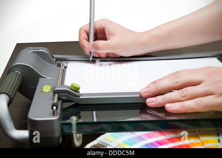 L'homme travaillant sur la guillotine pour le papier Banque D'Images