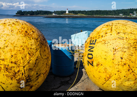 Une vue de la côte du Maine Lubec, avec un grand métal jaune flotter dans l'avant-plan Mulholland Point Lighthouse en arrière-plan. Banque D'Images