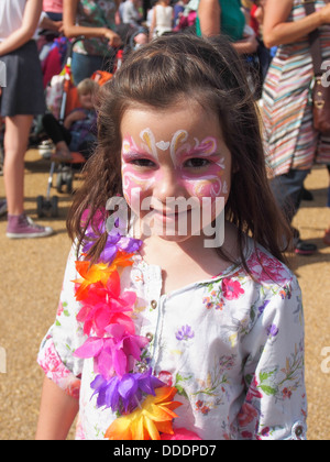 Jeune fille avec son visage peint et portant une guirlande de fleurs à un festival d'été Banque D'Images