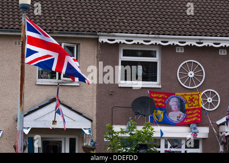 Une Union Jack flag vole d'une maison sur un ensemble immobilier dans l'ouest de Belfast protestantes en Irlande du Nord Banque D'Images