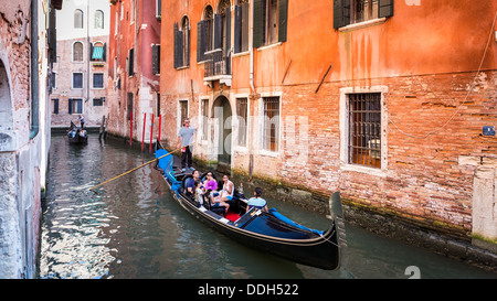 Gondoles de touristes voyageant à une rue de l'eau à Venise Italie Banque D'Images
