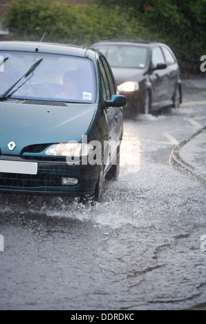 Les voitures qui circulent dans une route inondée, l'Écosse. Banque D'Images
