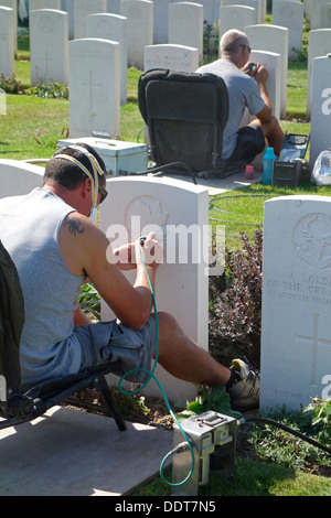 La restauration des graveurs de pierres tombales au cimetière de Tyne Cot de la Commonwealth War Graves Commission de soldats britanniques de la Première Guerre mondiale Banque D'Images