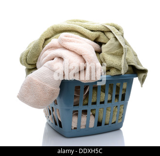 Libre d'un plein panier plein de serviettes. Sur le panier en plastique bourrés est isolé sur un fond blanc avec la réflexion. Banque D'Images