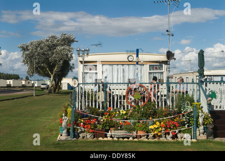 Static caravane maisons de vacances permanent camping St Osyth Essex Royaume-Uni. Famille dans leur jardin avant. St Osyth Beach Maison de vacances Chalet Park. Septembre 2013 2010s HOMER SYKES Banque D'Images