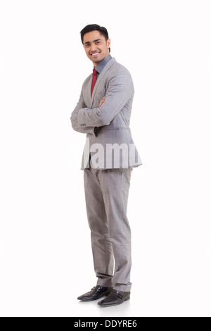 Full Length portrait of happy young man standing against white background Banque D'Images