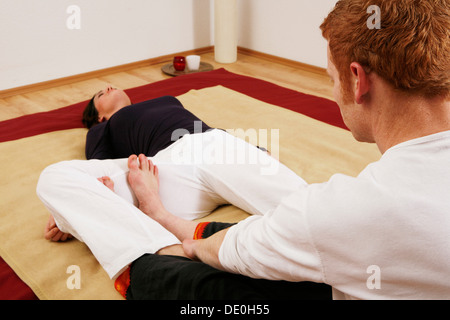 Jeune femme faisant des exercices de relaxation avec un entraîneur de qigong Banque D'Images