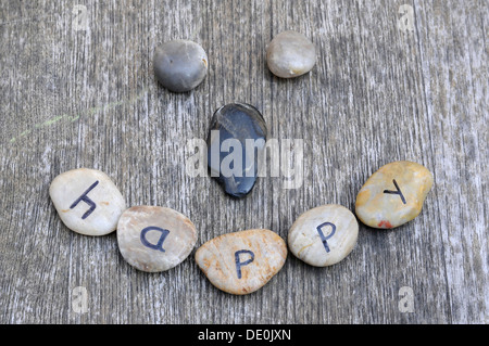 Pierres avec lettres formant un smiley, lettrage 'heureux' Banque D'Images