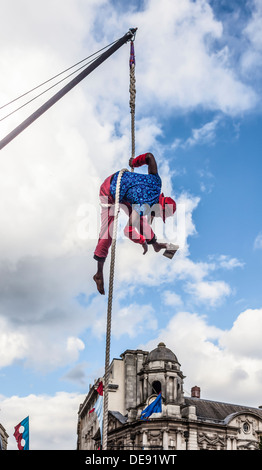 Acrobat à partir de No en état Circus group lire un livre suspendu à une corde. SquaresWeekender 4 festival, Birmingham. Banque D'Images