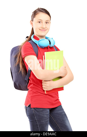 Une adolescente avec sac et écouteurs holding notebooks Banque D'Images