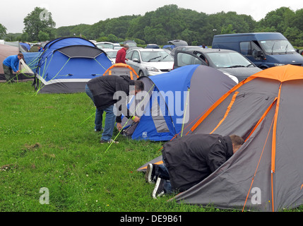 Campeurs heureux d'ériger une tente dans le cadre d'un festival ou un événement sportif (Grand Prix de F1) Banque D'Images