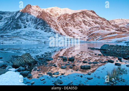 La première lumière sur Y Garn au-dessus Llyn Idwal en hiver, CWM Idwal, Parc National de Snowdonia, le Nord du Pays de Galles, Royaume-Uni Banque D'Images