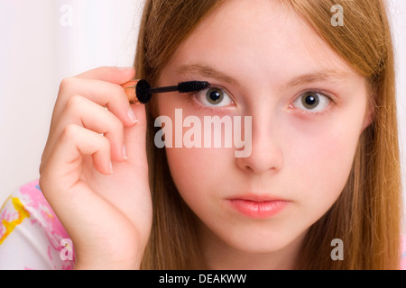 Fille, 17 ans, en mettant sur le mascara, portrait Banque D'Images