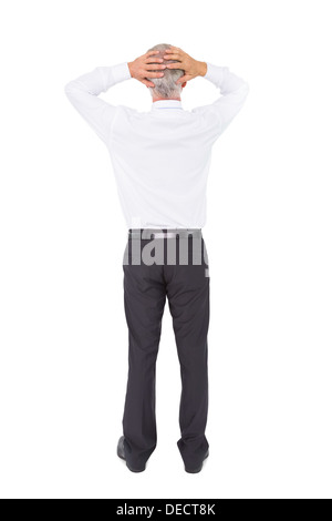 Businessman standing back to camera with hands on head Banque D'Images