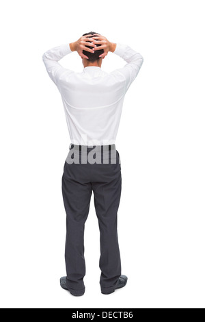 Businessman standing back to camera hands on head Banque D'Images