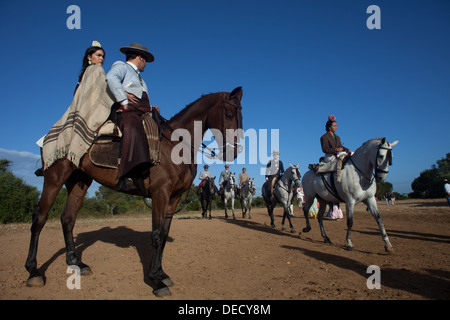 Dépasser quelques coureurs montant un cheval au cours du pèlerinage au sanctuaire de la Vierge du Rocio, en Andalousie, Espagne Banque D'Images