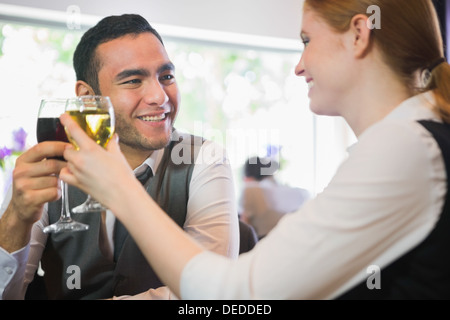Smiling business partners tintement des verres à vin Banque D'Images
