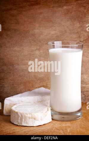 Verre de lait frais avec le brie et le camembert fromage sur un fond de bois Banque D'Images