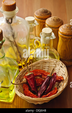 Piment séché avec de l'huile d'olive et condiments sur un fond de bois Banque D'Images