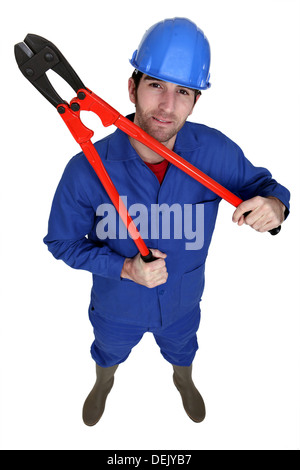 Construction Worker holding grandes pinces Banque D'Images