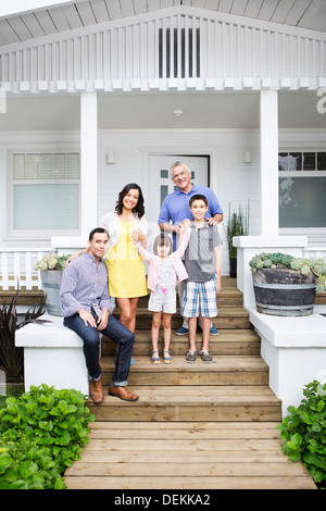 Family smiling together on porch Banque D'Images