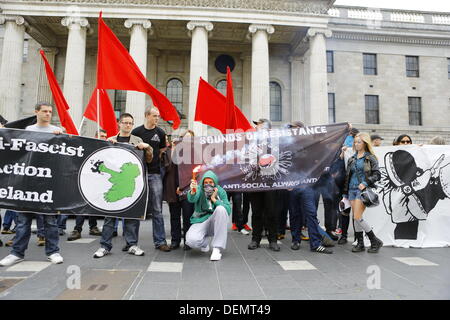 Dublin, Irlande. 21 septembre 2013. Un manifestant se trouve en face d'une bannière et des protestataires, est titulaire d'une torchère. Des militants anti-fascistes irlandais ont organisé une manifestation à l'appui de l'anti-fascistes grecs en dehors de la General Post Office (GPO). La manifestation suit jours après l'assassinat présumé de rappeur grec Pavlos Fyssas par un membre de l'extrême-droite du parti grec Aube dorée. Crédit : Michael Debets/Alamy Live News Banque D'Images