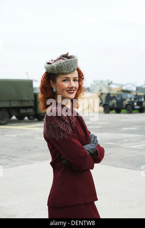 Chatham, Royaume-Uni. 21e Août, 2013. Salut à la 40's - Britain's 1940 Accueil/événement au Chatham Historic Dockyard. Lola Lamour, chanteuse de chansons des années 1940. À directement à huis clos avec des véhicules militaires derrière. Photo : Alamy Live News Banque D'Images