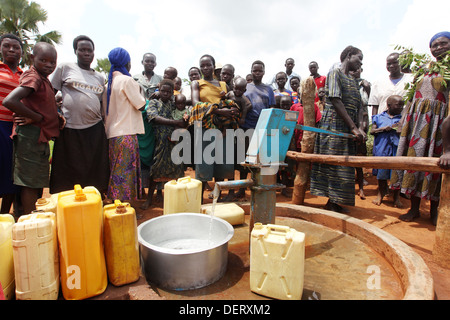 Les villageois recueillent de l'eau pompé par une ONG financée ainsi à côté de son village dans le district de Lira d'Ouganda du Nord. Banque D'Images