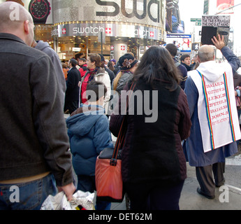 Des foules de touristes, consommateurs et d'un messager de Dieu congestionner les rues dans et autour de Times Square New York City. Banque D'Images