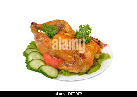 Poulet entier grill sur assiette de légumes Banque D'Images