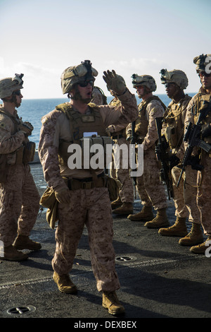 Les Marines américains affectés à l'entreprise, l'Équipe de débarquement du bataillon 3/2, 26e Marine Expeditionary Unit (MEU), sont informés sur les itérations cible au cours d'un exercice de tir réel sur le pont de l'USS San Antonio (LPD 17), en mer, le 12 septembre 2013. La 26e MEU est Banque D'Images