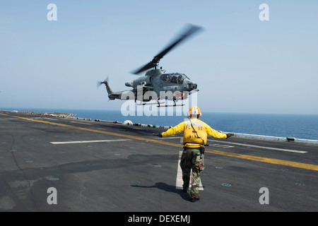 AH-1W Super Cobra du milieu marin de l'escadron à rotors basculants (VMM) 266 (rein) décolle de l'envol de l'assau amphibie Banque D'Images