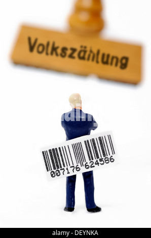 Holding miniature figure un code-barres en position debout en face d'un cachet portant la mention Volkzaehlung allemand, pour le recensement Banque D'Images